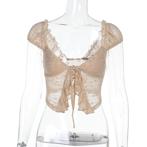 Detail showing delicate apricot lace texture and front tie design on the summer top