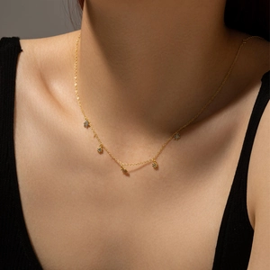 Elegant gold S925 silver necklace featuring five flower charms worn on the neck
