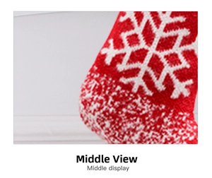 Detail of red knitted Christmas stocking featuring white snowflake patterns and texture