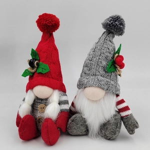Close-up of knit Christmas gnomes with wooden buttons and soft faux fur textures