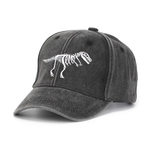 Detailed view of white dinosaur skeleton embroidery on washed cotton baseball cap