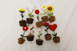 Top view of handmade crochet potted flowers including sunflower tulip and daisy designs