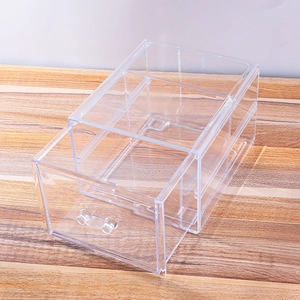 Transparent acrylic single drawer storage box with handle on a wooden tabletop