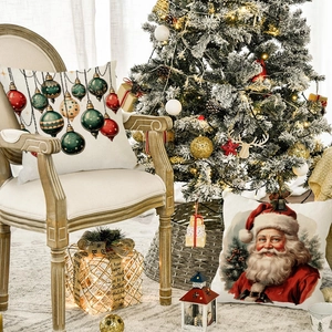 Close-up of linen Christmas pillows with Santa Claus and festive ornament prints