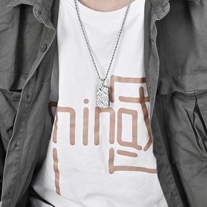Titanium steel dog tag necklace with bark texture and cross star detail on a male model