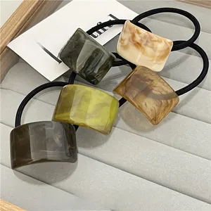 Set of 5 minimalist hair ties featuring amber and marble textured acrylic accents in earthy tones
