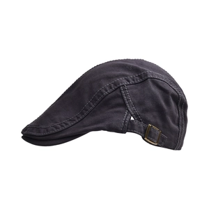 Close-up of bronze buckle and twill cotton fabric texture on dark grey beret cap