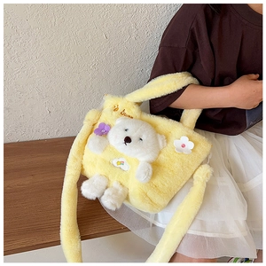 Detail of yellow plush kids handbag with 3D teddy bear and floral soft fabric textures