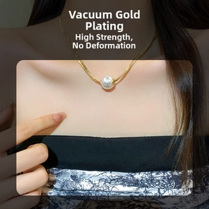 Close-up of vacuum gold-plated necklace with a pearl pendant on model neck