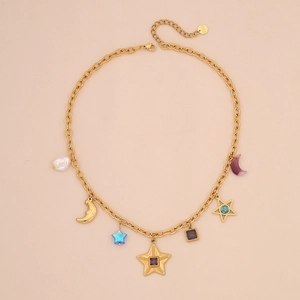 Detailed close-up of gold star and moon charms with blue gems and pearls on a dainty chain