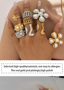 Close-up of 18K gold PVD plated rings with pearls showing high-polish texture and detail
