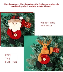 Detail of plush Santa and Reindeer fabric ornaments hanging on a Christmas tree
