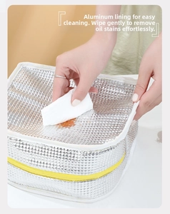 Detail of waterproof aluminum foil liner in lunch bag showing easy wipe cleaning feature