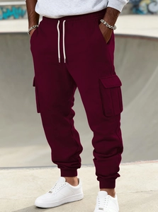 Detail of burgundy fleece cargo joggers with side pockets and elastic drawstring waist