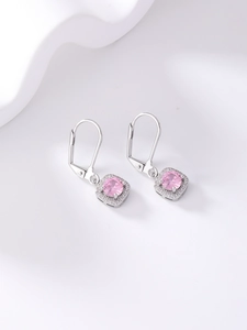 Detailed macro view of pink square zircon earrings with silver pavé diamond halo