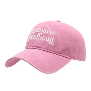 Pink washed cotton baseball cap with Expensive & Difficult embroidery at 45-degree angle