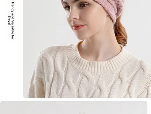 Detail of pink knit beanie with ponytail hole paired with white cable knit sweater