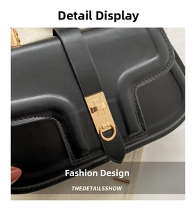 Detail view of black matte leather handbag with geometric lines and gold hardware