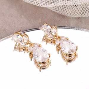 Elegant gold drop earrings with AAA water drop zircon on a reflective mirror surface