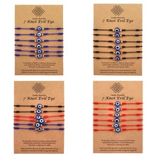 Detail view of woven lucky bracelets with 7 knots evil eye charm on display cards