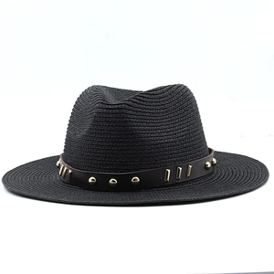 Detail of black straw fedora showing woven texture and leather band with gold metal studs