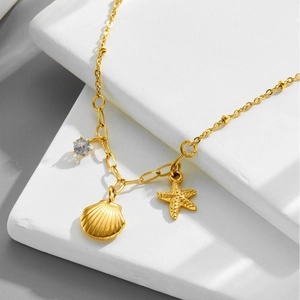 Golden stainless steel necklace featuring starfish, seashell charms and a round zircon gem