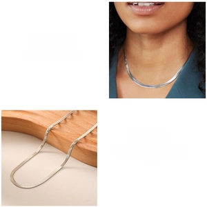 Detailed macro view of the sleek silver flat snake chain necklace with high-polish finish