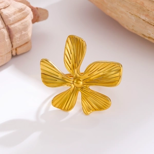 Macro shot of gold floral ring featuring five-petal rose design with embossed textures