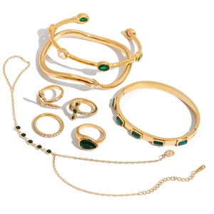 Golden stainless steel jewelry set featuring emerald green stones and assorted rings