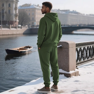 Men's dark green hooded tracksuit with waffle texture, outdoor winter riverside scene