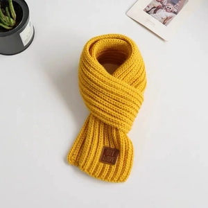 Cute yellow chunky knit scarf for toddlers with dinosaur theme and leather label tag
