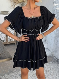 Detail showing the square neckline and white ruffle trim on a black mini summer dress