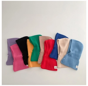 Flat lay of colorful ribbed knit kids balaclava hats with side button detail