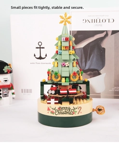 Close-up of rotating Christmas tree music box with colorful blocks and gift details