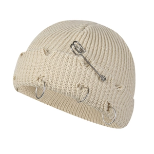 Chic beige knitted beanie with metal safety pin and rings featuring distressed rip design