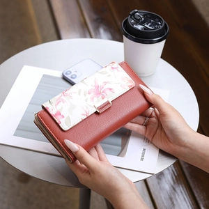 Detailed view of women long wallet with floral print, snap button and card slots