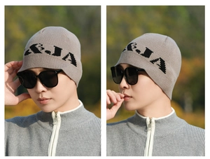 Detail of grey knitted beanie with letter jacquard and matching zip collar sweater