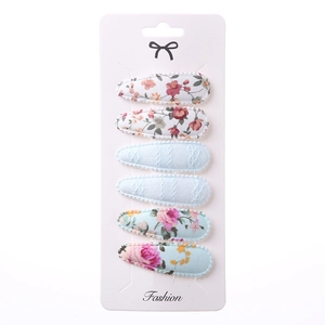 Set of 6 teardrop snap clips with floral embroidery and textured fabric on card