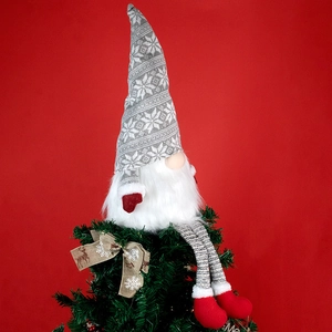 Gnome Christmas tree topper with grey knit hat and red boots on a pine tree star