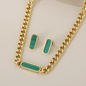 Detailed view of gold Cuban chain necklace and earrings with green malachite stone inlays