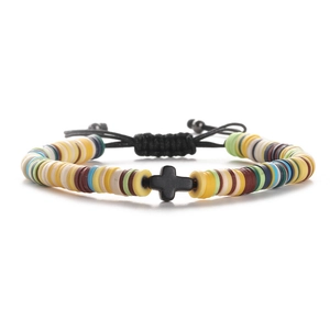 Detail of colorful heishi clay bead bracelet featuring a black cross charm and cord