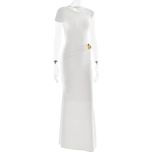 Detail of elegant white one-shoulder dress featuring a gold flower brooch on the waist