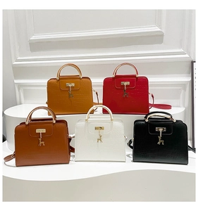 Detailed collection of crocodile pattern handbags with metal handles and reindeer charms