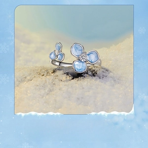 Detail view of S925 sterling silver ring with blue enamel flower and cubic zirconia