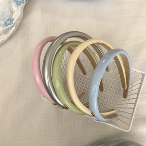 Chic PU leather headbands in multiple colors displayed in a white metal basket