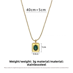 Detail of vintage gold stainless steel bead chain with a green stone pendant