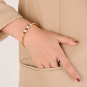 Detail of 18K gold snake chain bracelet with sparkling crystal beads on a model