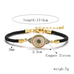 Detail of adjustable evil eye bracelet with copper zircon inlay and 3mm black braided rope