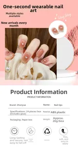 Close-up of pink gradient press-on nails featuring white heart patterns and French tips