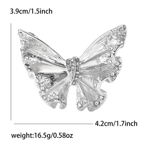 Detailed view of enamel butterfly brooch with silver texture, rhinestones and dimensions